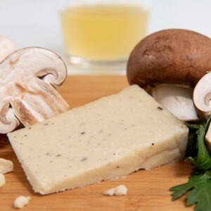 Vegan Gondino Truffle Parmesan Cheese Alternative by Pangea Foods served with mushrooms.
