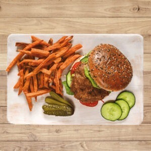 Veggyness Vegan Premium Burger Patty served in a burger bun with salad and sweet potato fries.