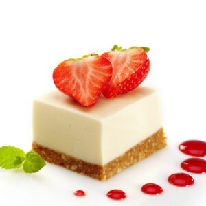 Vegan Classic Spreadable Cheese Alternative by MozzaRisella served in a vegan cheesecake with strawberries.