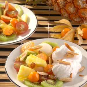 Vegan Spray Cream by Schlagfix served with fresh kiwi, pineapple, grapes, kumquats and nuts.