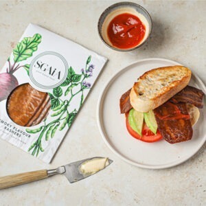 Vegan Smoky Flavour Bacon Rashers by Sgaia served in a sandwich with tomato, avocado and tomato sauce.