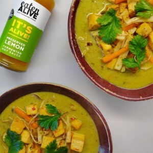 Vegan Preserved Lemon Fermented Hot Sauce by Eaten Alive served in a tofu Thai green curry with onion, carrots, and fresh coriander.