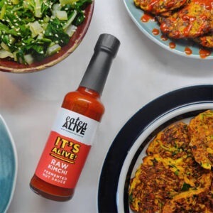 Vegan Raw Kimchi Fermented Hot Sauce by Eaten Alive served with vegetable fritters and salad.