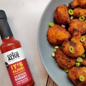 Vegan Scotch Bonnet Fermented Hot Sauce by Eaten Alive served with battered cauliflower bites and spring onions.