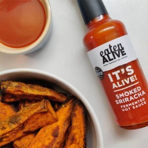 Vegan Smoked Sriracha Fermented Hot Sauce by Eaten Alive served as a dip with sweet potato fries.