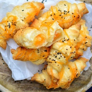 Vegan Cheddar Cheese Alternative Block by Greenvie served stuffed and over vegan croissants, topped with sesame seeds.