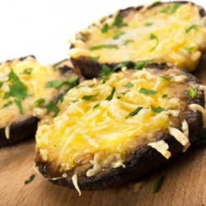 Vegan Smoked Gouda Cheese Alternative Block by Greenvie served melted in grilled mushrooms.