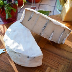 Vegan Camblue cheese alternative by Mouse's Favourite shown sliced on a vegan cheeseboard.