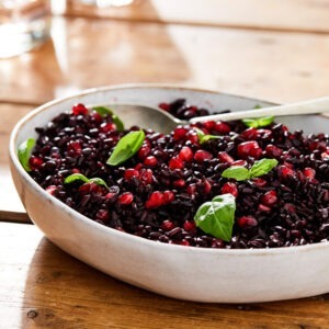 Black Nerone Rice by Seggiano served as a salad with pomegranate seeds and fresh basil.
