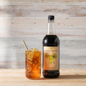 Vegan Jasmine Lime Iced Tea Syrup by Sweetbird served in a cool iced tea drink with ice and lime.