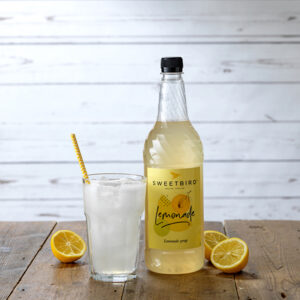 Vegan Plain Lemonade Syrup by Sweetbird served with soda water, ice and lemons.