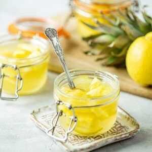 Vegan Tropical Jelly by Just Wholefoods served in jars topped with fresh lemon and pineapple.