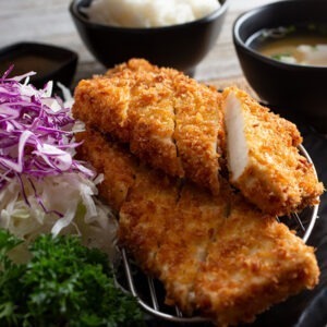 Extra Firm Tofu by Soyu served sliced and coated in breadcrumbs with red cabbage, sauerkraut and dips.