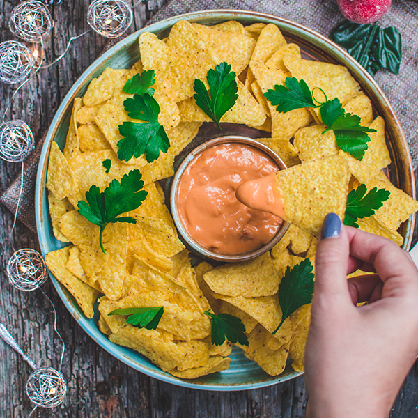Vegan Cheddar Cheese Dip Alternative by GreenVie served with tortilla chips.