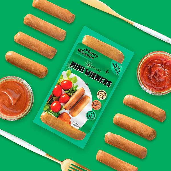 Vegan Mini Wiener Sausages by Plenty Reasons shown next to pots of tomato ketchup.