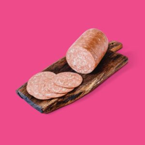 Vegan Salami Block by Plenty Reasons shown presented on a wooden board.