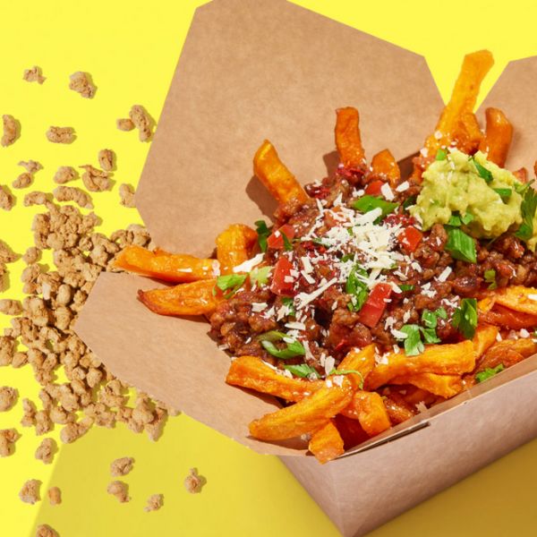 Vegan Original Instant Hack Mince by Sunflower Family served on top of sweet potato fries with guacamole and spring onions.
