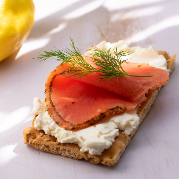 Vegan Gravlax by Revo Foods served with vegan cream cheese and fresh dill on a cracker.