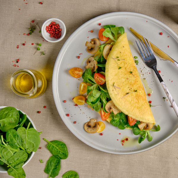 Vegan vEGGe by The Alternative Food served as a folded omelette filled with greens and vegetables.