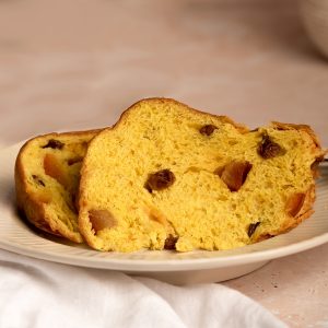 Vegan Panettone by Seggiano. Shown sliced, on a plate.