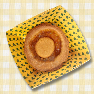 Vegan Apricot Tart by The Alternative Food. Shown in cardboard tray, on gingham cloth-effect background.